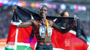 Mary Moraa, with a radiant smile, proudly displays her bronze medal at the 2024 Paris Olympics. Her athletic build and focused expression reflect the dedication and hard work that have propelled her to become one of Kenya's leading middle-distance runners