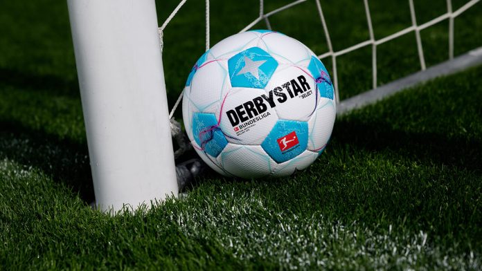 Close-up of a Bundesliga football on the pitch with the league's logo visible.