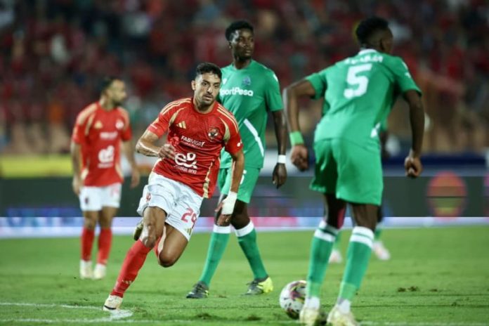 Gor Mahia players in action against Al Ahly during the CAF Champions League match, with Al Ahly players pressing high and controlling possession.