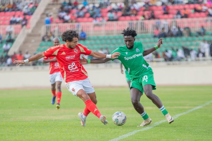 K'Ogalo Austin Odhiambo competing for the ball with Al Ahly's Mohamed Hany in a Caf Champions League match at Nyayo Stadium.