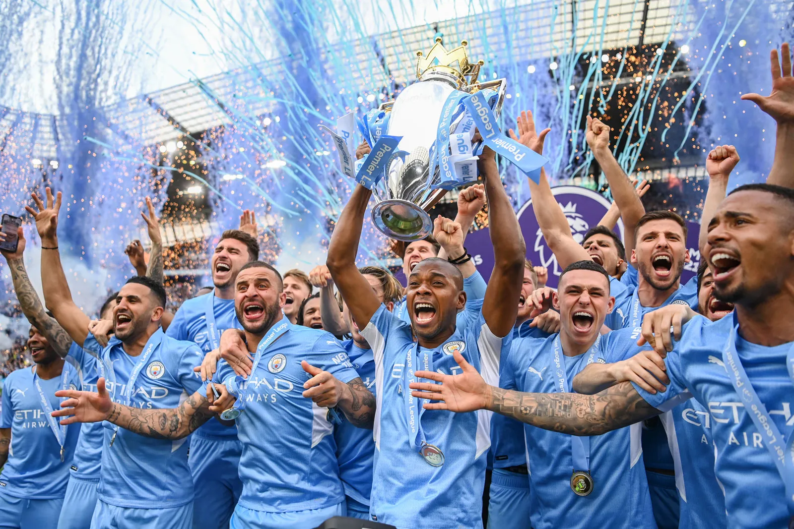 Manchester City celebrates their Premier League triumph, lifting the trophy aloft in a moment of pure elation and achievement.