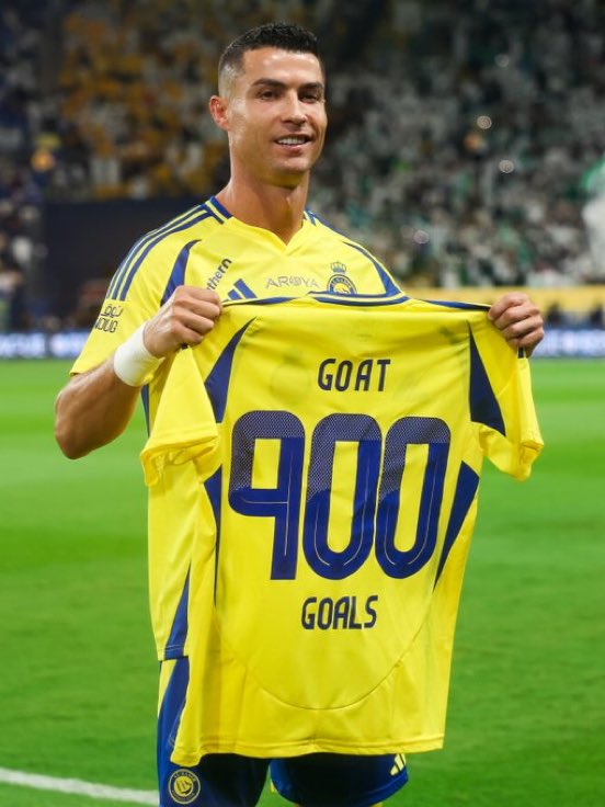 Ronaldo holds his GOAT jersey after hitting 900 career goals