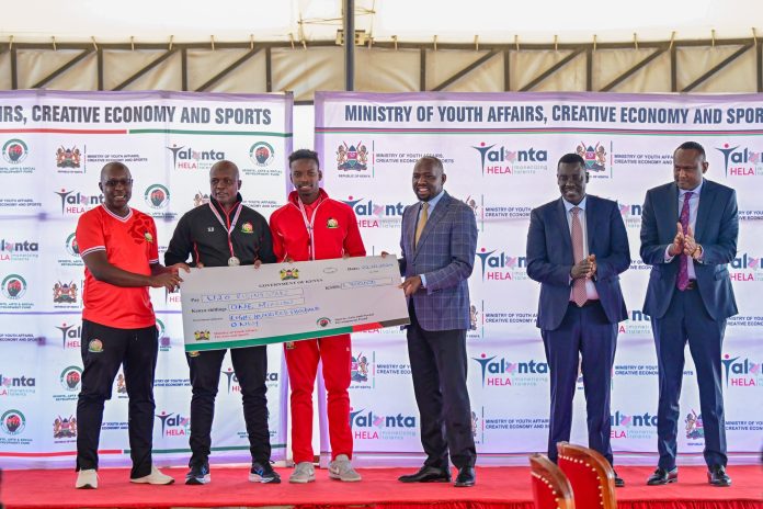 Cs Murkomen handing over 1.8 million cheque to Kenya U20 Coach Salim Babu