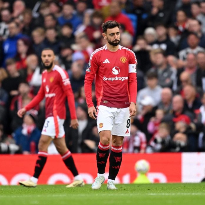 Bruno Fernandes expressing frustration as he is shown another red card during Manchester United's intense clash against FC Porto, marking his second dismissal in just five days.