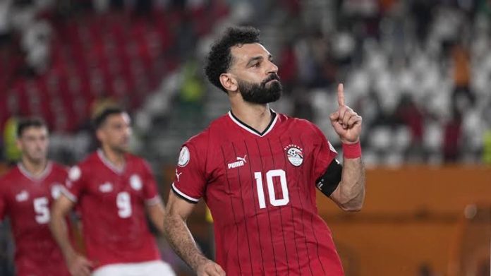 egypt Mohamed Salah celebrates after scoring a goal during an AFCON qualifier, raising his finger in a gesture of triumph.