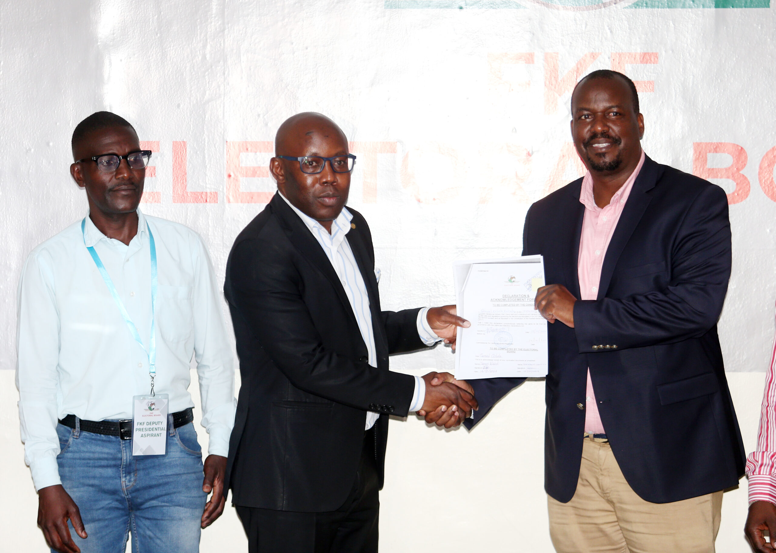 FKF-Election-Board-chairman-Hesbon-Owilla-handover-certificate-of-Registration-to-Sam-Ochola-with-his-Runningmate-Willis-Waliaula-