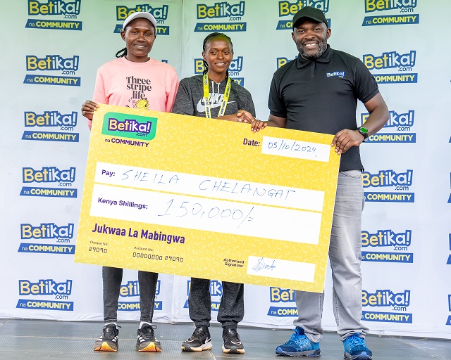 Sheila Chelangat who finished-first-in-the-womens category receiving a bumper cheque