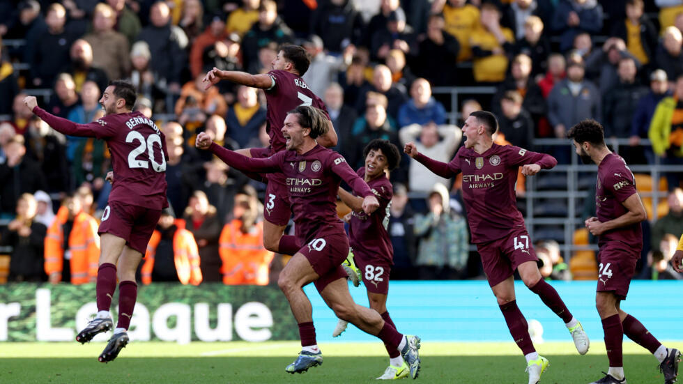 Manchester City players celebrate after last minute John Stones's goal confirmed by VAR