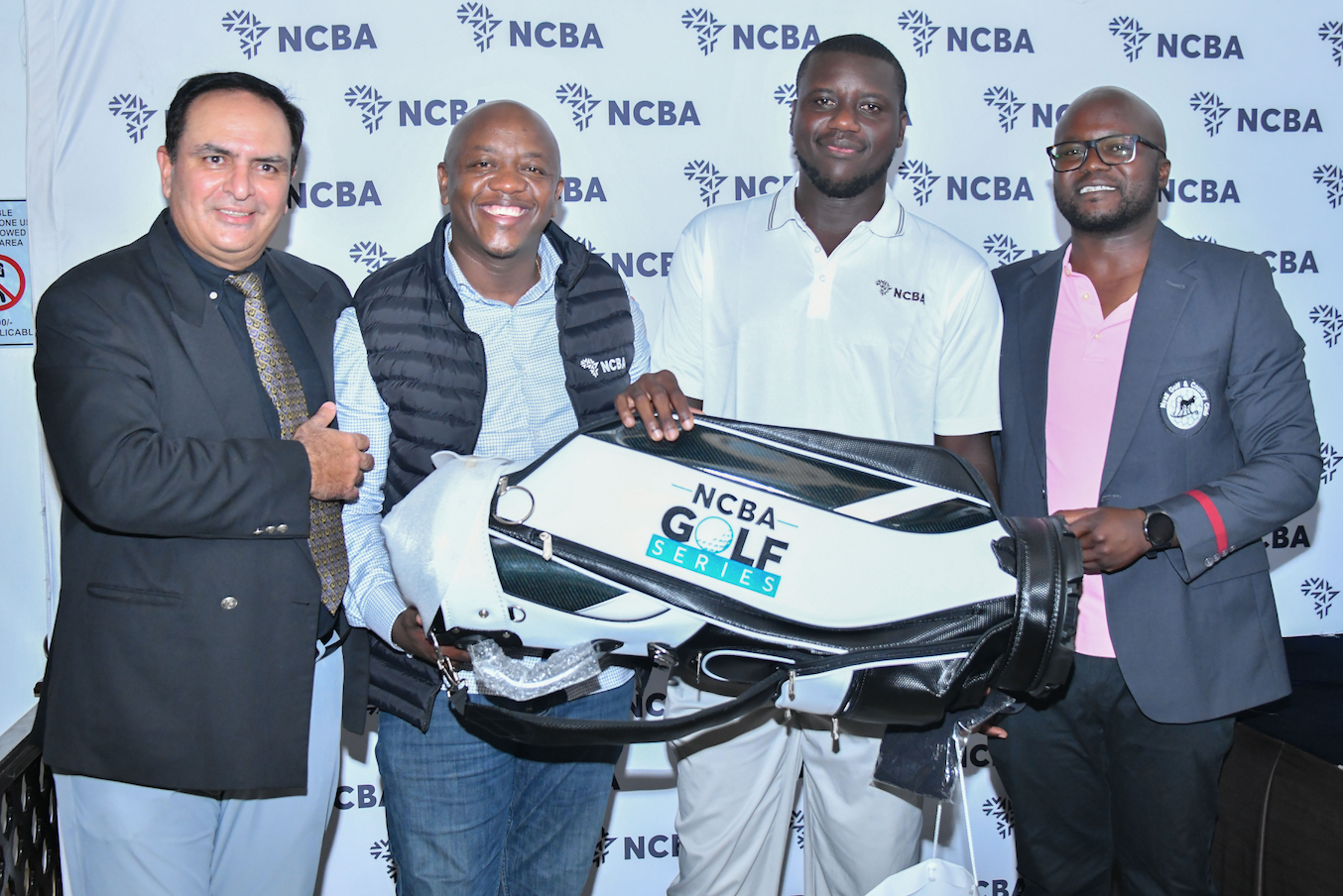 Men’s Division One winner Emmanuel Lumatete (second from right) is awarded by NCBA’s Dennis Njau alongside Nyali Golf Club captain Dinesh Saasan (left) and vice captain Allan Mola (right)