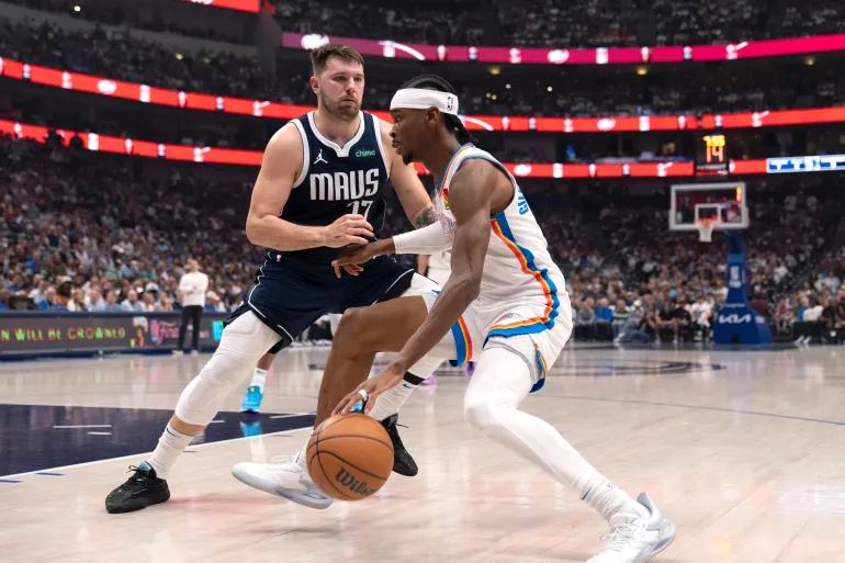 Oklahoma City Thunder guard Shai Gilgeous-Alexander, right, and Luka Doncic (77) of the Dallas Mavericks going head-to-head in the 2024 NBA Playoffs second-round series on May 13, 2024