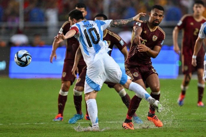 Argentina's players battle for possession against Venezuela during their CONMEBOL World Cup Qualifier, pushing for a breakthrough in a tightly contested match