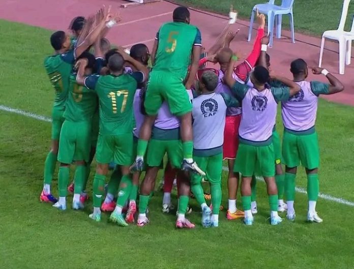 afcon qualifiers 2025 .Comoros football team celebrates their 1-0 win against Tunisia during the AFCON qualifiers, with players huddled together in joy.