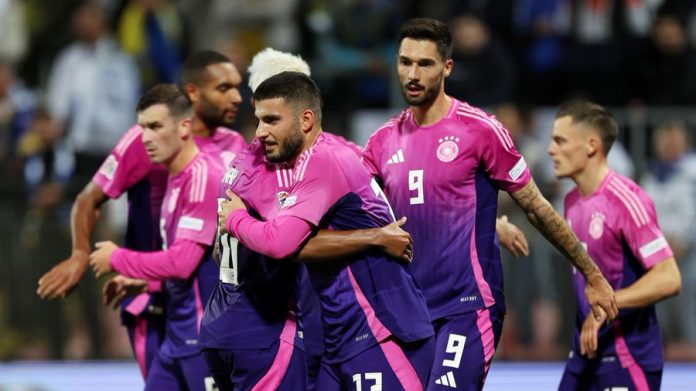 Germany players in purple kits celebrate Deniz Undav's goal during their Nations League match against Bosnia and Herzegovina.