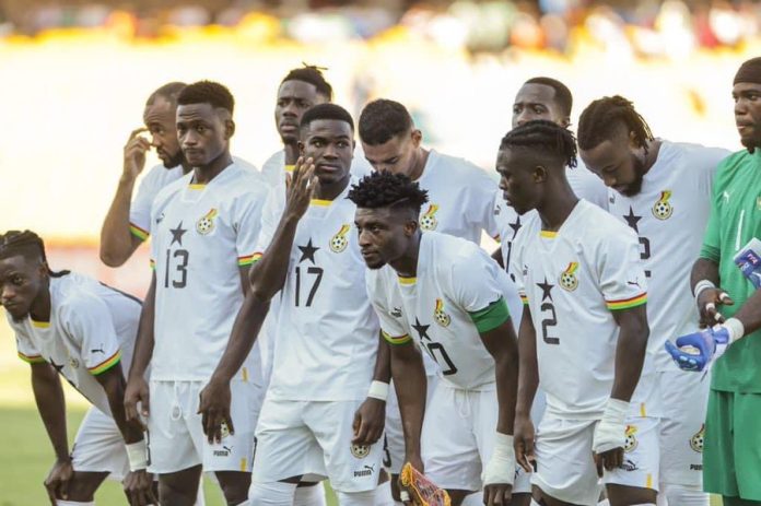 Ghana Black Stars football team standing together in white jerseys with a focused expression before a crucial AFCON qualifier match.