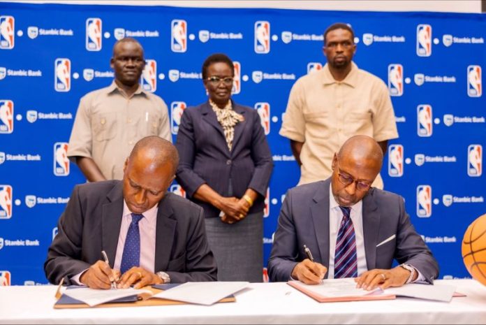 NBA Africa and Safaricom officials signing a partnership agreement for a youth basketball initiative in Kenya.