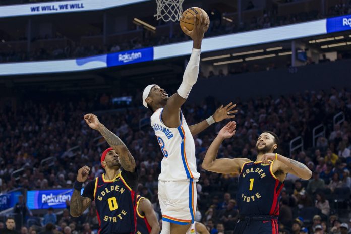 Nov 27, 2024; San Francisco, California, USA; Oklahoma City Thunder guard Shai Gilgeous-Alexander (2) lays up the ball infant over Golden State Warriors forward Kyle Anderson (1) and guard Gary Payton II (0) during the first half at Chase Center. (Photo: John Hefti-Imagn Images/REUTERS)
