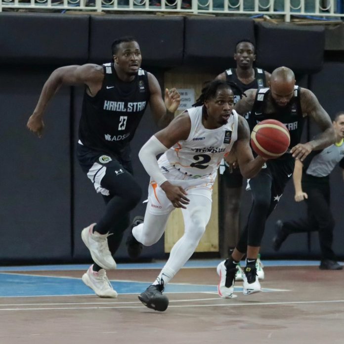 Uchenna Iroegbu (U.C.), the American-Nigerian point guard for Nairobi City Thunder, drives past defenders from Kriol Star during their BAL Elite 16 match at Nyayo Gymnasium