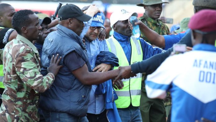 AFC Leopards coach Tomas Trucha being escorted as he escapes wrath of angry fans after Ulinzi Stars loss