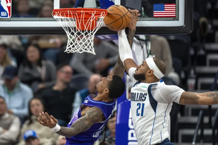 Dallas Mavericks center Daniel Gafford (21) blocks a shot by Utah Jazz forward John Collins, left, during the first half of an NBA basketball game Thursday, Nov. 14, 2024, in Salt Lake City. (AP Photo/Rick Egan)ASSOCIATED PRESS