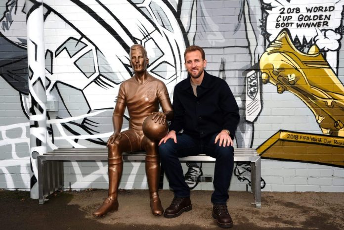 Harry Kane (right) alongside the statue in London. Zac Goodwin/PA Images via Getty Images