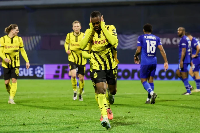 Jamie Gittens delivered a stunning goal to propel Dortmund to victory over Zagreb, securing their place in the Champions League top four.