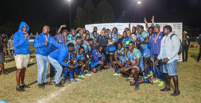 Kenya Rugby Union President Sasha Mutai hands over the Impala Floodlit winners’ trophy to Menengai Oilers captain Ibrahim Ayoo and his teammates on November 2, 2024 at Impala Club in Nairobi.