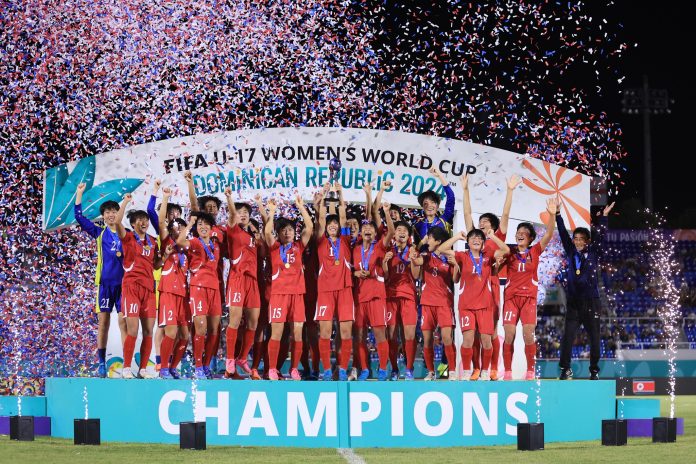 SANTO DOMINGO, DOMINICAN REPUBLIC - NOVEMBER 03: Kuk Hyang Ri of North Korea lifts with teammates the winner's trophy following the FIFA U-17 Women's World Cup Dominican Republic 2024 Final match between Korea DPR and Spain at Felix Sanchez Stadium on November 03, 2024 in Santo Domingo, Dominican Republic. (Photo by Buda Mendes - FIFA/FIFA via Getty Images)