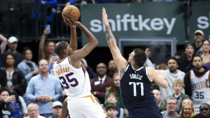 - Nov 8, 2024; Dallas, Texas, USA; Phoenix Suns forward Kevin Durant (35) shoots over Dallas Mavericks guard Luka Doncic (77) during the fourth quarter at American Airlines Center. Mandatory Credit Kevin Jairaj-Imagn Images