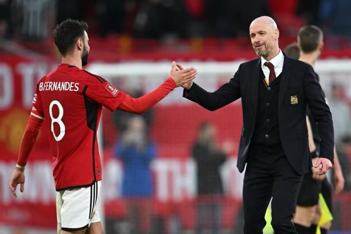 Fernandes shaking hands with Erik ten Hag during a Manchester United match.