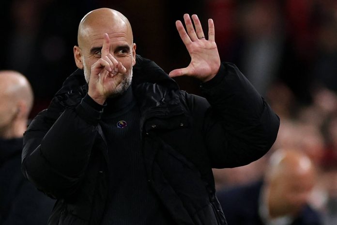 Manchester City manager Pep Guardiola gestures toward Liverpool fans at Anfield in Liverpool, England, on Sunday. | AFP-JIJI