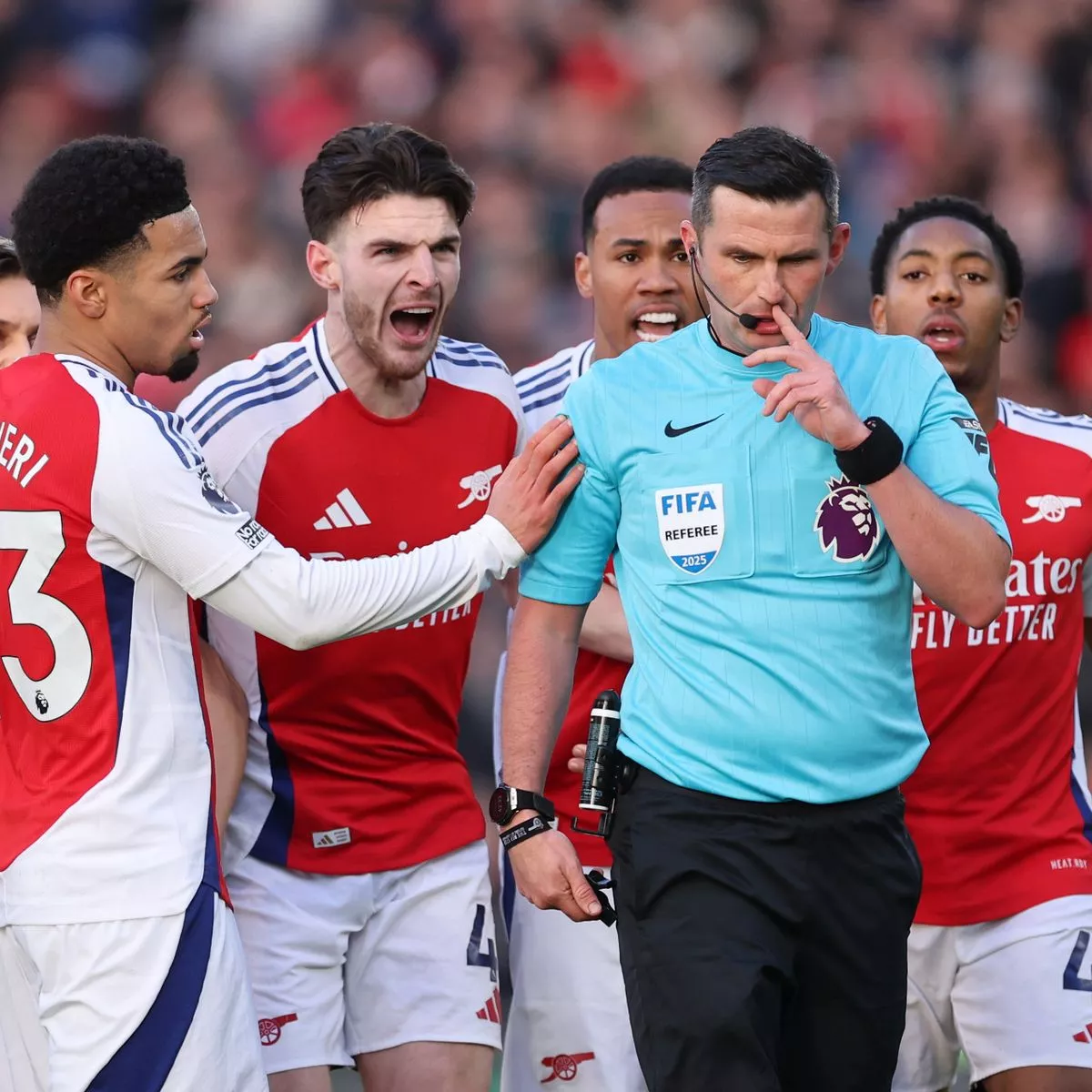 PGMOL -Referee Michael Oliver is pursued by angry Arsenal players after his decision to send off Myles Lewis-Skelly in the first half at Molineux. Photograph: Neal Simpson/Getty Images/Allstar