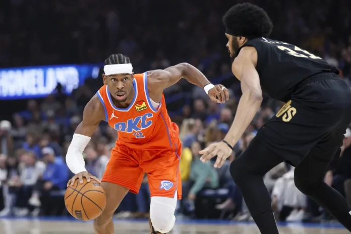 Oklahoma City Thunder guard Shai Gilgeous-Alexander, left, drives against Cleveland Cavaliers center Jarrett Allen, right, during the first half of an NBA basketball game Thursday, Jan. 16, 2025, in Oklahoma City. (AP Photo/Nate Billings)ASSOCIATED PRESS