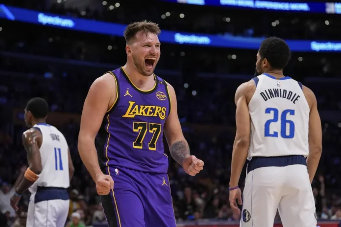 Los Angeles Lakers guard Luka Doncic (77) reacts next to Dallas Mavericks guard Spencer Dinwiddie (26) after scoring an drawing a foul during the first half of an NBA basketball game Tuesday, Feb. 25, 2025, in Los Angeles. (AP Photo/Mark J. Terrill)