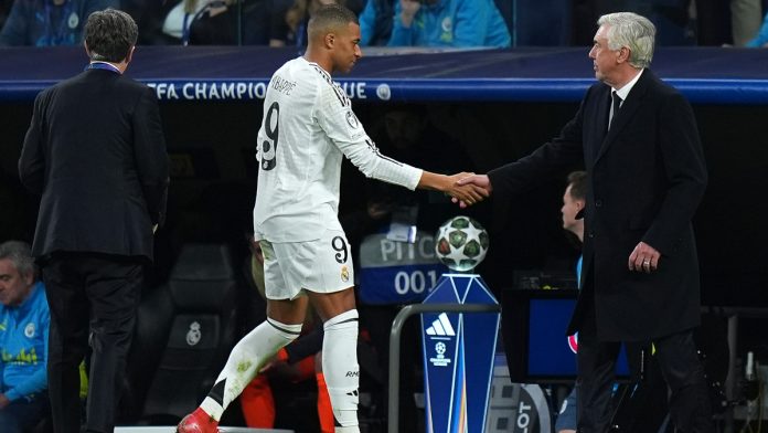 MADRID, SPAIN - FEBRUARY 19: Kylian Mbappe is embraced by Carlo Ancelotti, Head Coach of Real Madrid, after being substituted off during the UEFA Champions League 2024/25 League Knockout Play-off second leg match between Real Madrid C.F. and Manchester City at Santiago Bernabeu Stadium on February 19, 2025 in Madrid, Spain. (Photo by Angel Martinez/Getty Images)