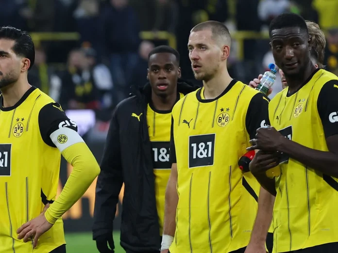 Waldemar Anton (second right) and Serhou Guirassy (right) face Dortmund’s fans after their side’s 2-1 defeat to Stuttgart. Photograph: Action Press/Shutterstock