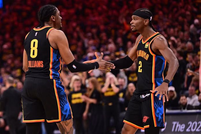Jalen Williams (left) and Shai Gilgeous-Alexander of the Oklahoma City Thunder celebrate during the first half against the Nuggets JOSHUA GATELEY / GETTY IMAGES NORTH AMERICA / Getty Images via AFP