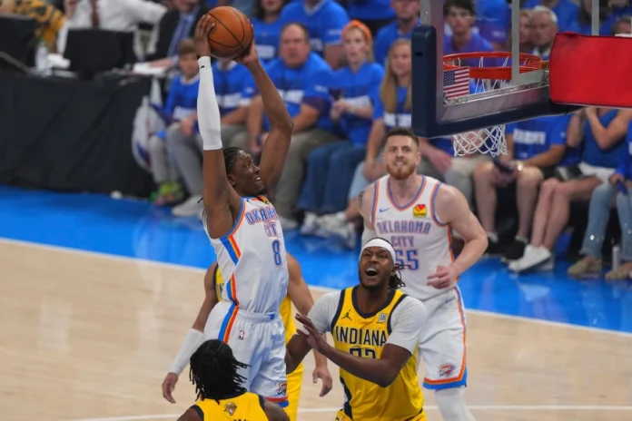 Oklahoma City Thunder forward Jalen Williams (8) dunks over Indiana Pacers center Myles Turner during the first half of Game 5 of the NBA Finals basketball series, Monday, June 16, in Oklahoma City. (AP Photo/Kyle Phillips)