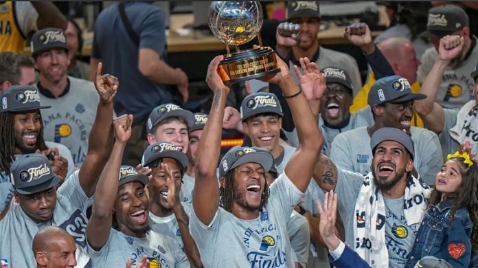 Indiana Pacers center Myles Turner holds the trophy as players celebrate after winning Game 6 of the Eastern Conference finals of the NBA basketball playoffs against the New York Knicks in Indianapolis, Saturday, May 31, 2025. AP Photo/AJ Mast